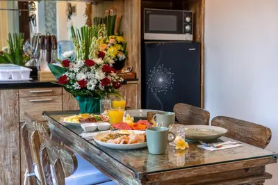 a table with plates of food on it in a kitchen at Arts Cherry Villa Dua Two-Bedroom with Private Pool Kuta in Kerobokan