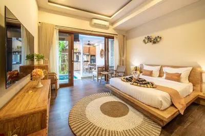 a bedroom with a bed and a living room at Arts Cherry Villa Dua Two-Bedroom with Private Pool Kuta in Kerobokan