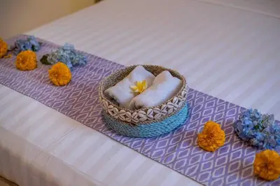 a basket of towels and flowers on a bed at Bens Bidadari Villa Two-Bedroom with Private Pool Kuta in Seminyak