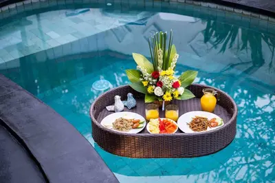a table with food in a swimming pool at Bens Bidadari Villa Two-Bedroom with Private Pool Kuta in Seminyak