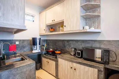 a kitchen with a sink and a microwave at Bens Kenanga Villa Three-Bedroom with Private Pool Kuta in Kerobokan