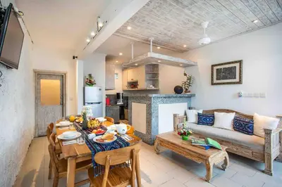 a living room with a table and a couch at Bens Kenanga Villa Three-Bedroom with Private Pool Kuta in Kerobokan