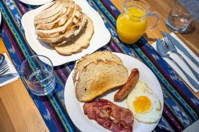 two plates of breakfast food with eggs bacon and toast at Bens Kenanga Villa Three-Bedroom with Private Pool Kuta in Kerobokan