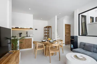 a living room with a table and a couch at White Residence - Art & Boutique Villas in Seminyak
