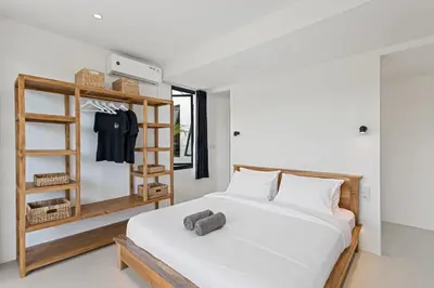 a bedroom with a white bed and a shelf at White Residence - Art & Boutique Villas in Seminyak