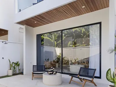 a living room with a table and chairs at White Residence - Art & Boutique Villas in Seminyak