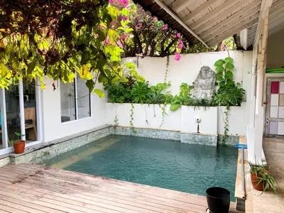a swimming pool in the backyard of a house at Tropical Oasis 2 BR Villa - Near Beach in Seminyak