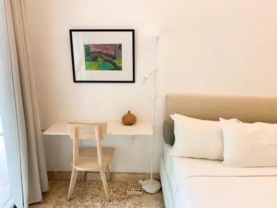 a bedroom with a bed and a table and a desk at Tropical Oasis 2 BR Villa - Near Beach in Seminyak