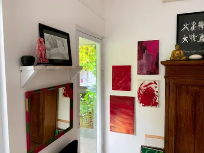 a living room with a mirror and paintings on the wall at Tropical Oasis 2 BR Villa - Near Beach in Seminyak