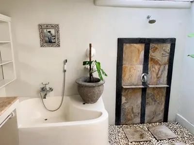 a bathroom with a sink and a potted plant at Tropical Oasis 2 BR Villa - Near Beach in Seminyak