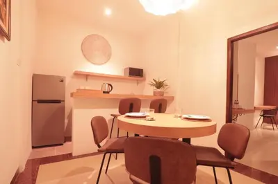 a kitchen and dining room with a table and chairs at Amaya Residence Jimbaran in Jimbaran