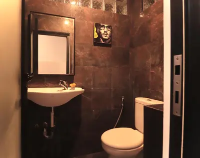 a bathroom with a toilet and a sink and a mirror at Amaya Residence Jimbaran in Jimbaran