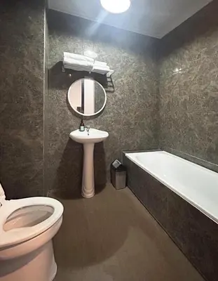 a bathroom with a toilet and a sink and a tub at Amaya Residence Jimbaran in Jimbaran