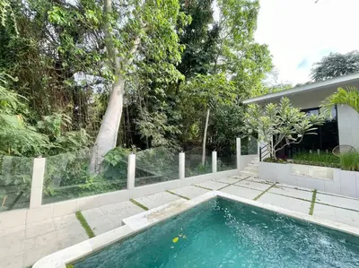 a swimming pool in the backyard of a house at Villa EM Umalas by Satran Villa in Kerobokan