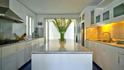 a kitchen with a vase of flowers on a counter at Casa Evaliza by Elite Havens in Seminyak