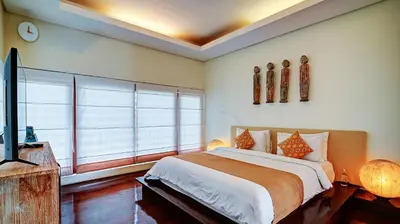 a bedroom with a bed and a large window at Casa Evaliza by Elite Havens in Seminyak