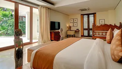 a bedroom with a large bed and a television at Casa Evaliza by Elite Havens in Seminyak