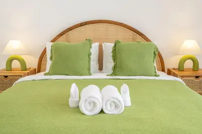 a bed with two white towels on top of it at Semera - Luxury Villa with a Spacious Pool in the Prime Location in Kerobokan