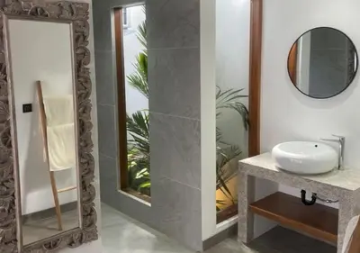 a bathroom with a sink and a mirror at Villa La madrina in Kerobokan
