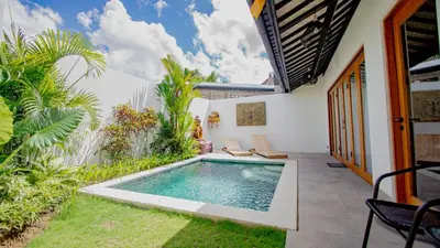 a swimming pool in the backyard of a house at Villa La madrina in Kerobokan