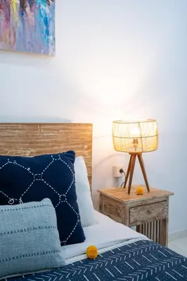 a bedroom with a bed and a lamp on a table at Bali Huis Villa in Seminyak
