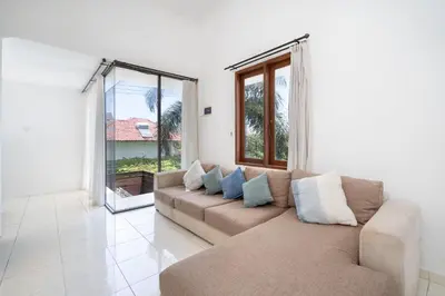 a living room with a couch and some windows at Bali Huis Villa in Seminyak