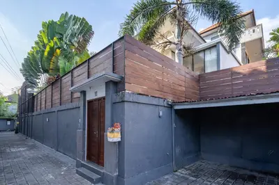 a building with a wooden fence on top of it at Bali Huis Villa in Seminyak