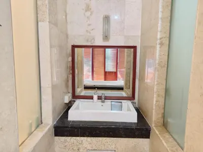 a bathroom with a white sink and a mirror at Privat Pool Villa at Kuta in Kuta
