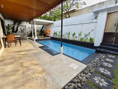 a swimming pool in the backyard of a house at Privat Pool Villa at Kuta in Kuta