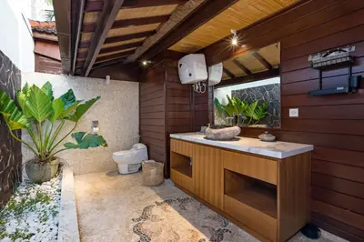 a bathroom with a toilet and a sink at Palm Merah Villa in Umalas