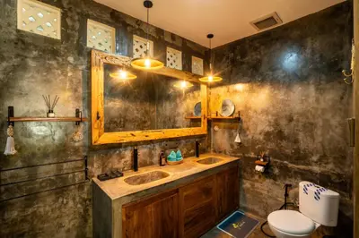 a bathroom with a sink and a mirror and a toilet at Lovely 1 BR villa walking distance to the beach in Seminyak