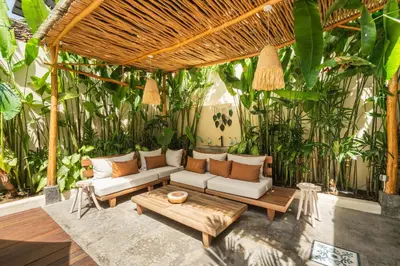 a patio with a couch and a table at Lovely 1 BR villa walking distance to the beach in Seminyak