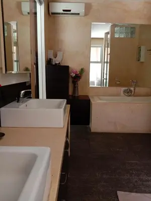 a bathroom with two sinks and a tub and a mirror at J & J villa Seminyak in Seminyak