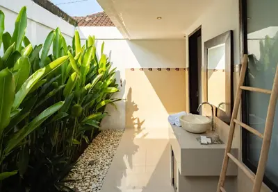a bathroom with a sink and some plants at Gemstones Villa in Seminyak