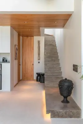 a hallway with a staircase in a house at Vaya - Luxe & Stylish 3BR Villa Just Steps from the Beach in Seminyak