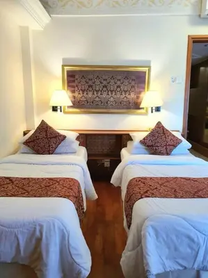 a hotel room with three beds and two lamps at C&C Apartment Jayakarta Residence Legian Bali A 6319 in Seminyak
