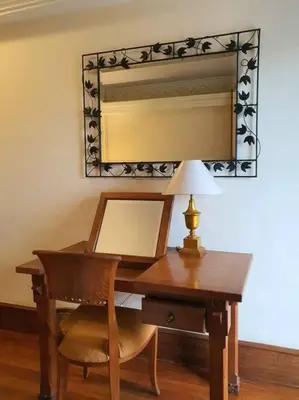 a wooden desk with a lamp and a mirror at C&C Apartment Jayakarta Residence Legian Bali A 6319 in Seminyak