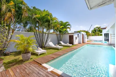 an image of a swimming pool in a backyard with palm trees at Villa Anzo by DreamAwayBali in Seminyak