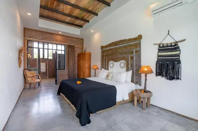 a bedroom with a king sized bed in a room at Villa Anzo by DreamAwayBali in Seminyak