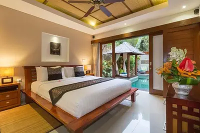 a bedroom with a large bed and a large window at Villa Green Mango 2 Seminyak Bali in Seminyak