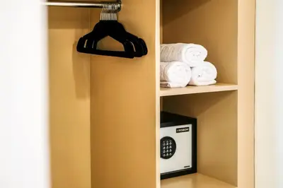 a closet with a towel rack and a microwave at Casa De Beji Seminyak in Seminyak