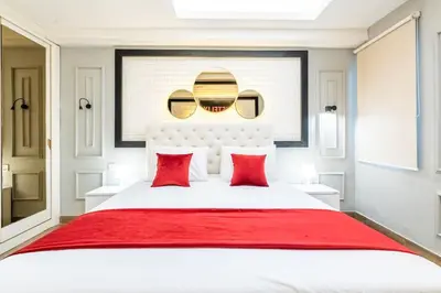 a bedroom with a large white bed with red pillows at Luxury Villa Belvedere Bali in Seminyak in Seminyak
