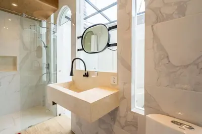 a bathroom with a sink and a mirror and a shower at Luxury Villa Belvedere Bali in Seminyak in Seminyak