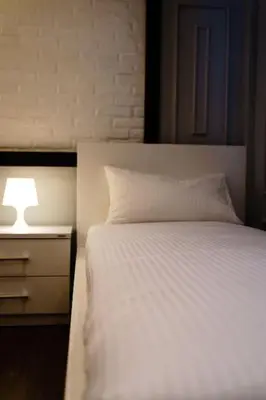 a bedroom with a white bed and a nightstand with a lamp at Luxury Villa Belvedere Bali in Seminyak in Seminyak