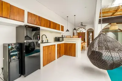 a kitchen with a hammock hanging from the ceiling at La Feliz Villa Seminyak in Seminyak
