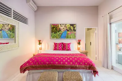 a pink bedroom with a large bed with pink sheets at Villa Bloom 3 - Coastal Beach Villa 2 brm Sleeps 4 SEMINYAK BEACH in Seminyak