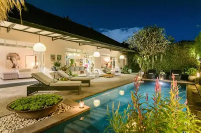 a house with a swimming pool at night at Villa Bloom 3 - Coastal Beach Villa 2 brm Sleeps 4 SEMINYAK BEACH in Seminyak