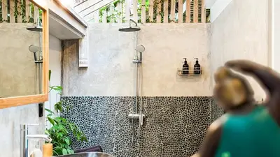 a bathroom with a shower with two bottles on a shelf at Villa Sukacita - Family Friendly 4BR Seminyak Eat Street 900m Walk To Beach in Seminyak