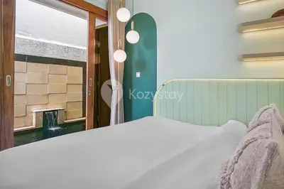 a bedroom with a white bed and a window at Calisee Villa by Kozystay - Denpasar in Seminyak