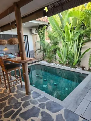 a swimming pool in the middle of a house at Villa crush of heart with swimming pool in Umalas
